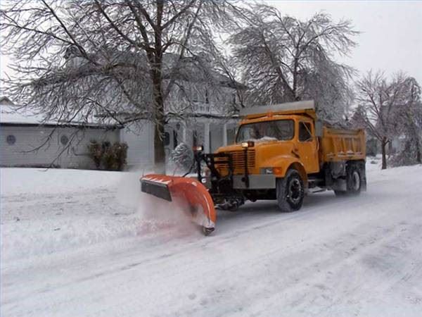 Yellow Snow Plow Clearing a Neighborhood Street